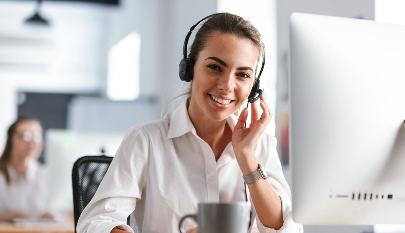 Smiling young woman wearing microphone headset